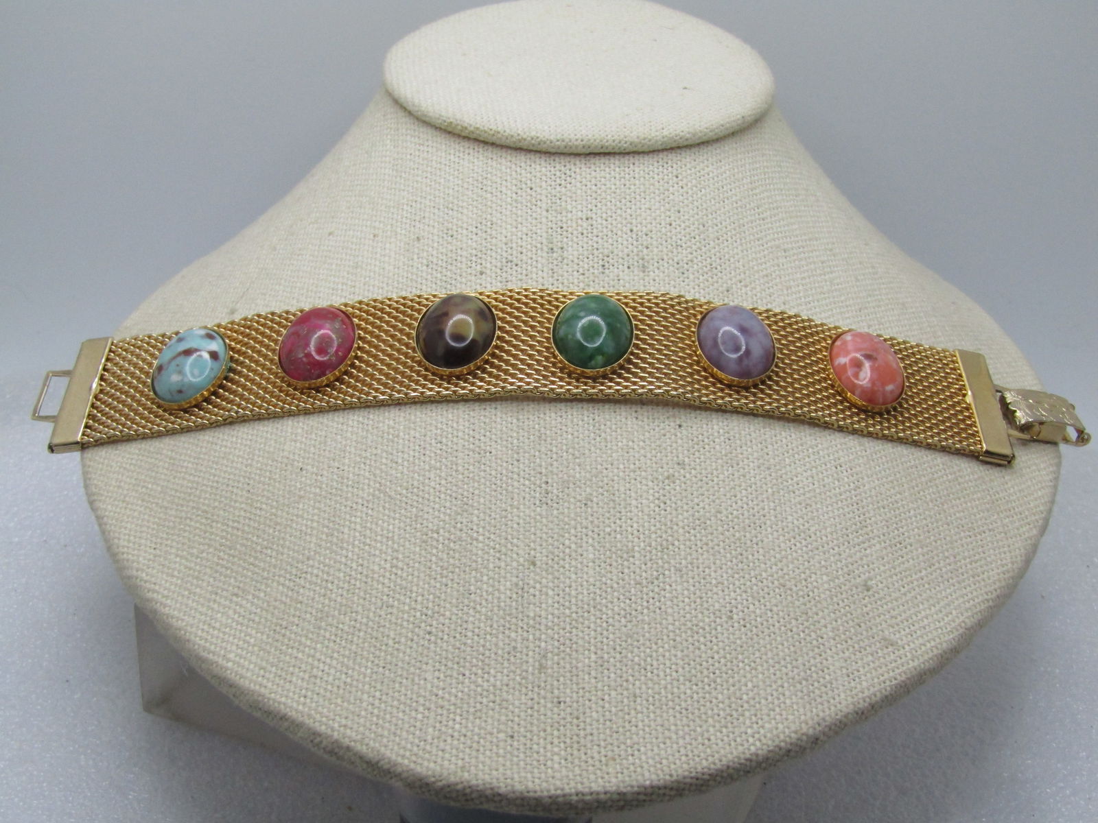 Vintage Faux Agate Mesh Bracelet, 7.5", Sarah Coventry, 1960's-1970's: Vintage Faux Agate Mesh Bracelet, 7.5", Sarah Coventry, 1960's-1970's. Gold tone and appx. 1" wide with six faux agate cabochons in turquoise, red, brown, green, lavender, and pink. Wide decorative