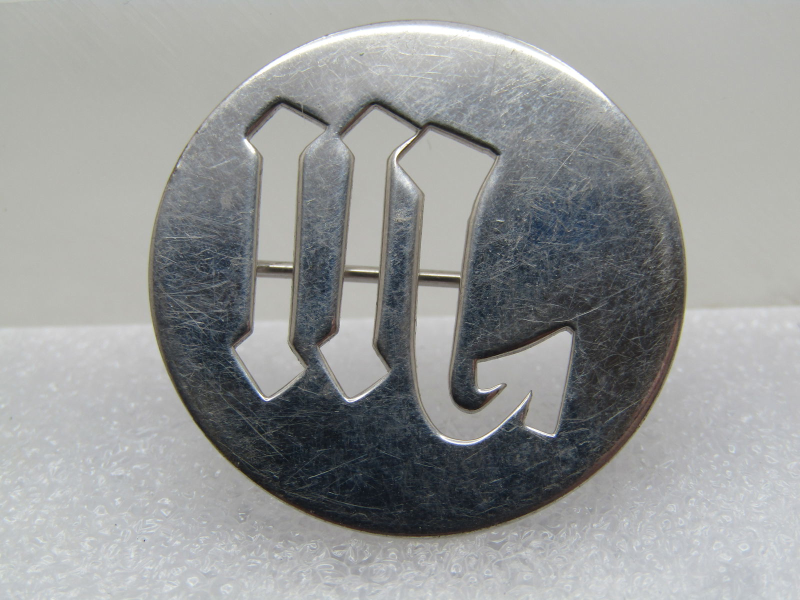 Vintage Sterling Initial W Brooch, Signed WRE, 1960's-1970's: Vintage Sterling Initial W Brooch, Signed WRE, 1960's-1970's. W E Richards' cut out what appearls to be an initial W (could be M) 1-1/8" round brooch. It is marked Sterling and WRE. Tests as