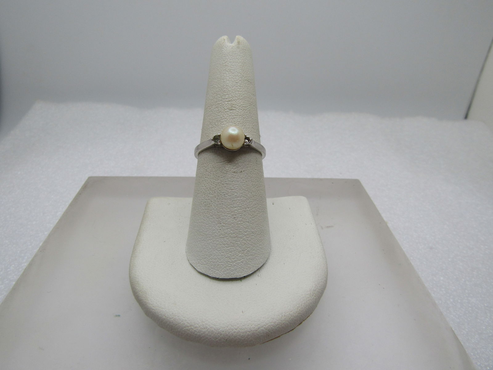 Vintage Faux Pearl & Rhinestone Ring, Sz. 7.5, 1970's-1980's: Vintage Faux Pearl & Rhinestone Ring, Sz. 7.5, 1970's-1980's. This has an appx. 5.5mm pearl with a clear 1.5mm rhinestone on each side. Silver tone - it is not marked or signed. Great for the June bir