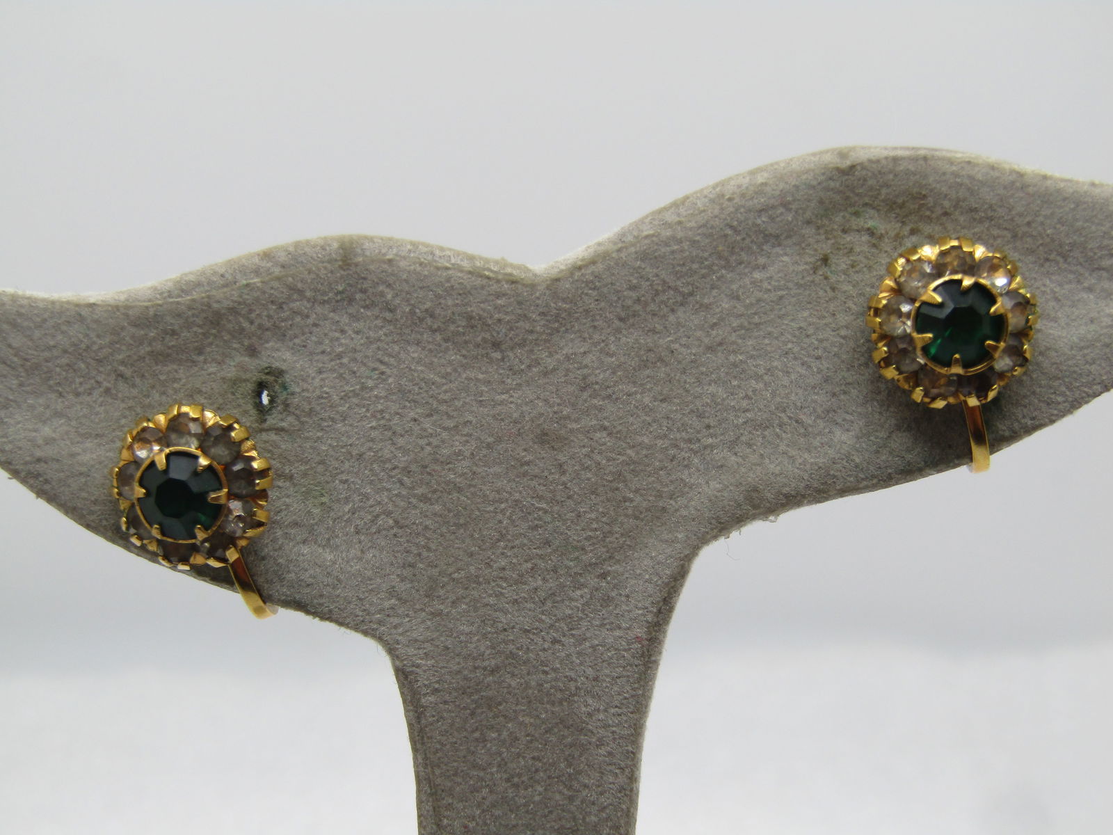 Vintage 12KT GF Green And Clear Halo Rhinestone Earrings, Screwback, 1940's.: Vintage 12KT GF Green And Clear Halo Rhinestone Earrings, Screwback, 1940's. Gold tone with a raised appx. 5mm prong-set emerald green rhinestone at center and a halo of appx. 2mm clear rhinestones se