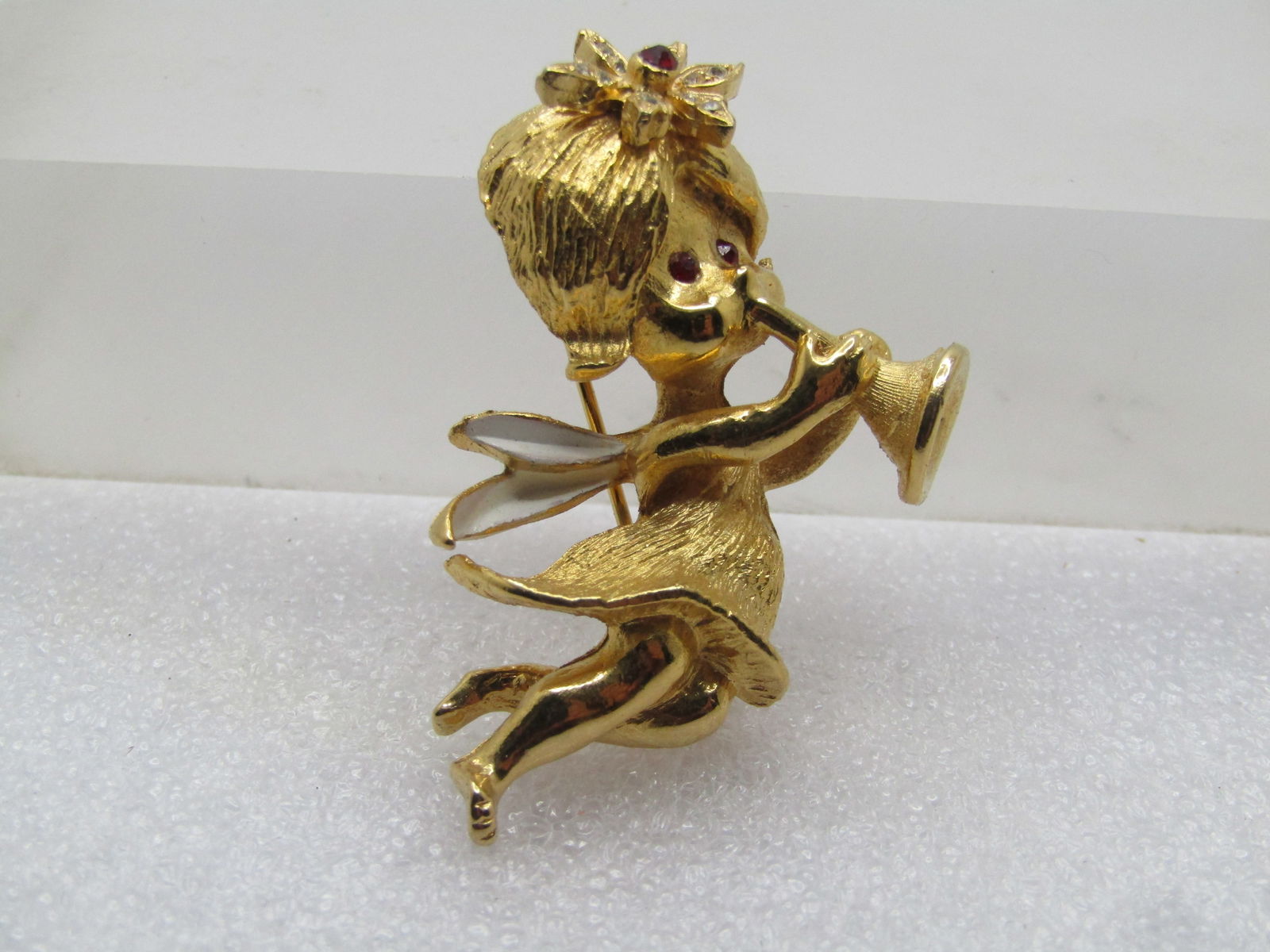 Vintage Fairy/Angel Brooch, Blowing Horn, 1960's-1970's: Vintage Fairy/Angel Brooch, Blowing Horn, 1960's-1970's. This reminds my of similar MYLU signed pieces, thought this is not signed. Textured gold tone with long locking clasp. The fairy/angel has