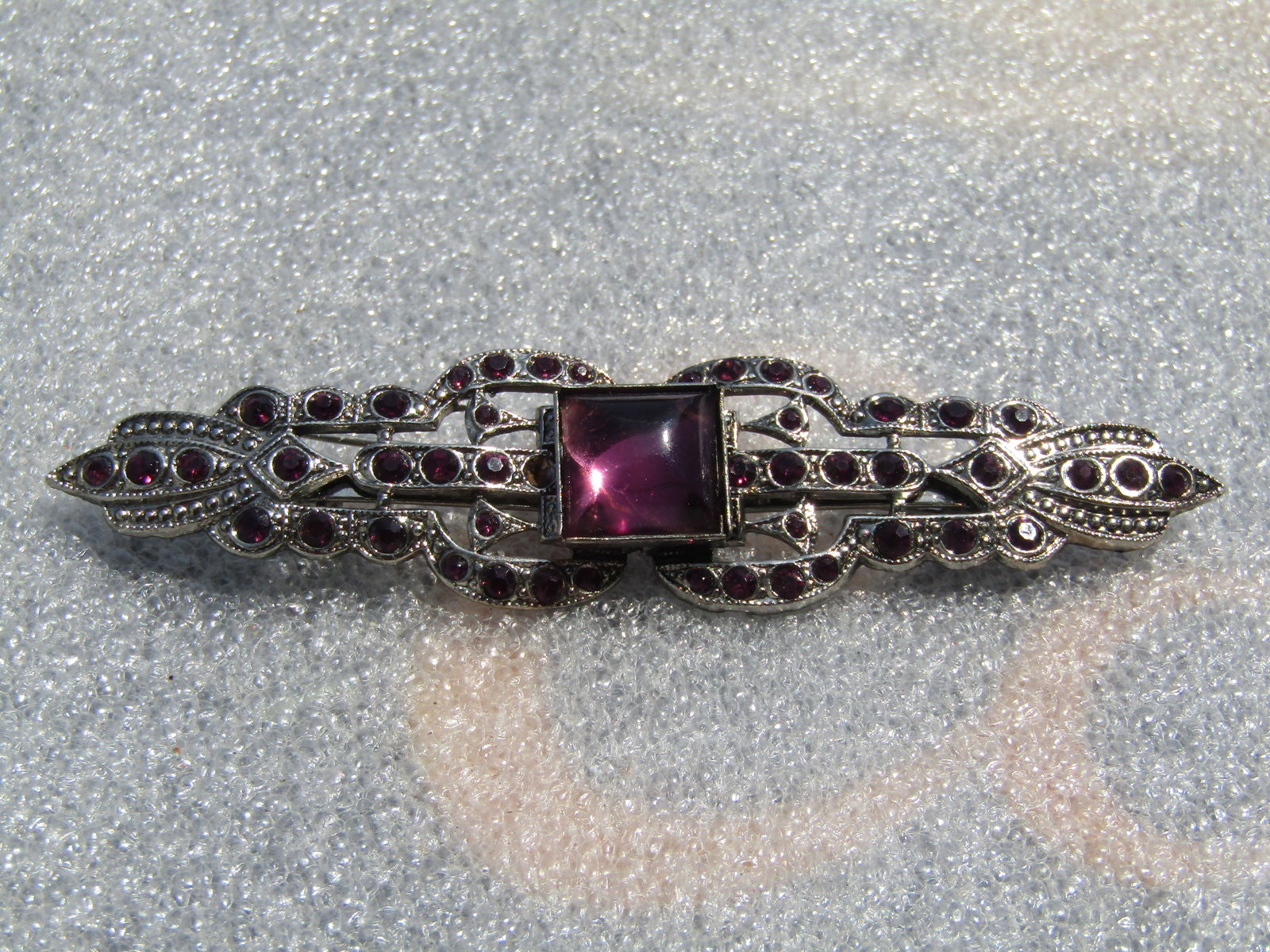 Vintage Purple Rhinestone Wide Brooch, Victorian Themed, 1980's: Vintage Purple Rhinestone Wide Brooch, Victorian Themed, 1980's. Silver tone with round purple rhienstones that are appx. 2mm to 2.5mm set throughout the frame of the brooch with a Victorian theme