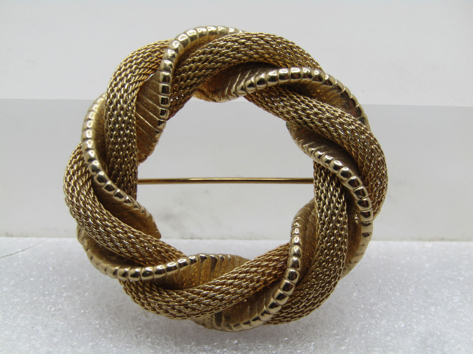 Vintage Gold Filled Mesh Circle Brooch, 1960's: Vintage Gold Filled Mesh Circle Brooch, 1960's. This is appx. 8.5mm wide twisted mesh and ridged wrap that makes up the circle that is appx. 1.75" across. Locking clasp. It tests as 10kt G.F. 