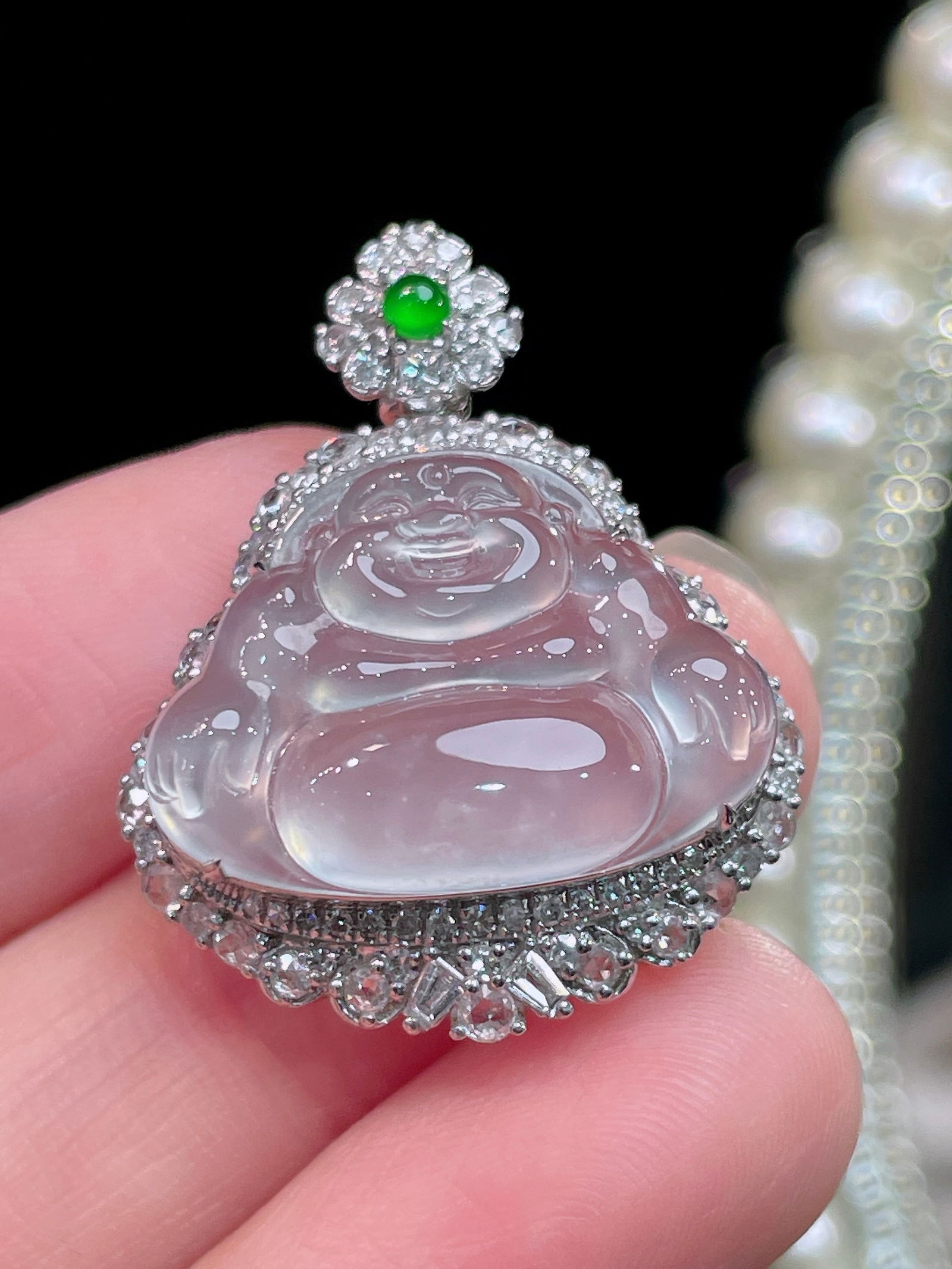 White ice jadeite Buddha pendant: Title: White ice jadeite Buddha pendant Description: This pendant showcases the serene beauty of Buddha, meticulously carved from white jade and set in 18k gold with sparkling diamonds. The exquisite