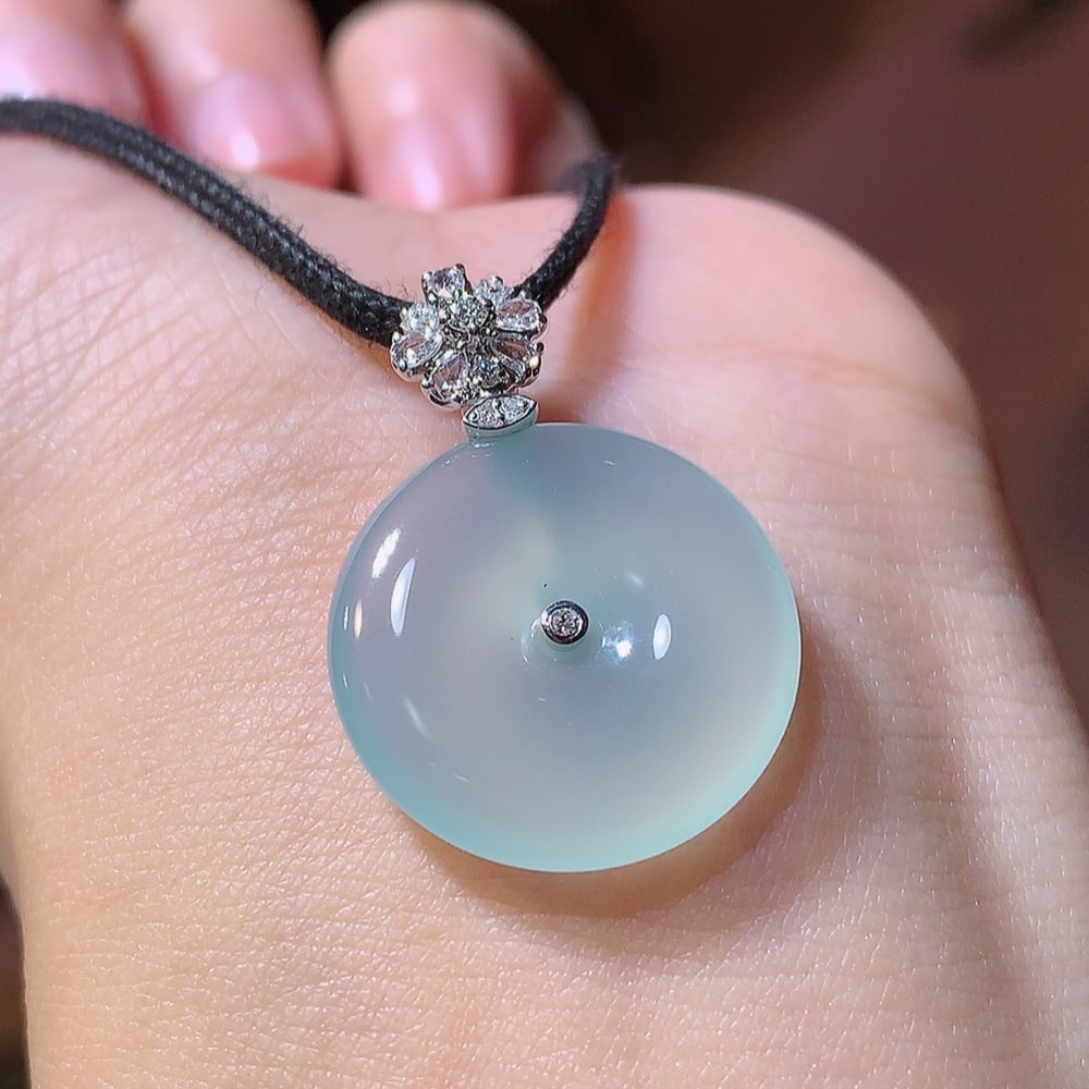 High Ice Jadeite Pendant: Title: High Ice Jadeite Pendant Description: This high ice Ping An buckle pendant showcases eternal elegance, with its delicate texture and glossy luster being admirable. The transparent and elegant