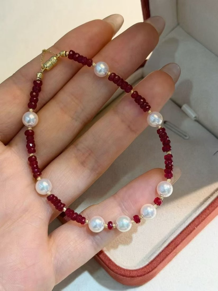 18K Gold Ruby and Pearl Bracelet: Title: 18K Gold Ruby and Pearl Bracelet Description: This exquisite bracelet perfectly combines the fiery charm of natural rubies with the eternal elegance of Japanese Akoya pearls. Each ruby is