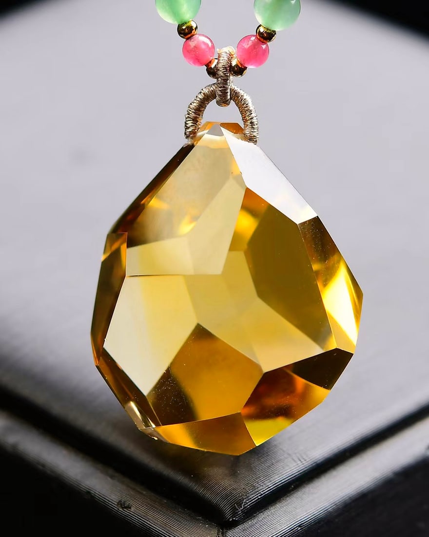 Brazilian Yellow Citrine Faceted Pendant: Title: Brazilian Yellow Citrine Faceted Pendant Description: This pendant showcases the essence of elegance, meticulously crafted from top-quality natural yellow crystal, with each angle shining with