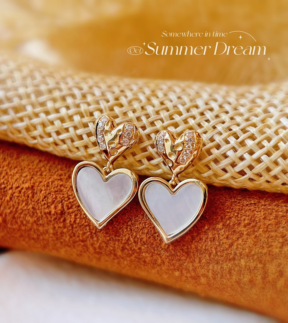 18k Diamond Heart Earrings: Title: 18k Diamond Heart Earrings Description: These earrings capture the essence of romance with their striking heart-shaped design. Crafted from 18k gold, they are adorned with sparkling diamonds