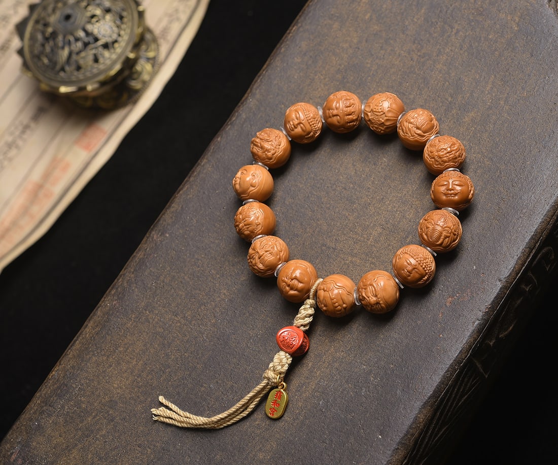 Wanfo Monkey Head Walnut Bracelet: Title: Wanfo Monkey Head Walnut Bracelet Description: This bracelet is a stunning piece of art, meticulously carved from natural original seed monkey head walnut. Each bead is a testament to