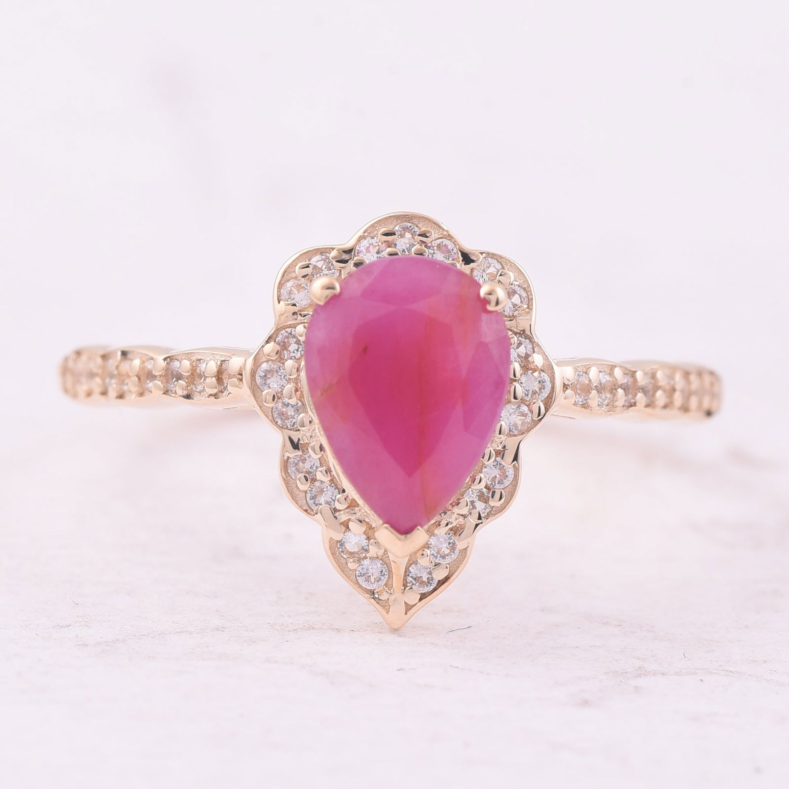 1.25 Ct Pear Ruby 9K Gold Ring: 1.25 Total Carat Ruby 9K Gold Ring Specifications - Total Weight 1.771 g - Center Gemstone Ruby - Gemstone Carat Weight 1.08 Carats - Gemstone Measurements 8X6 mm - Additional Gemstones White