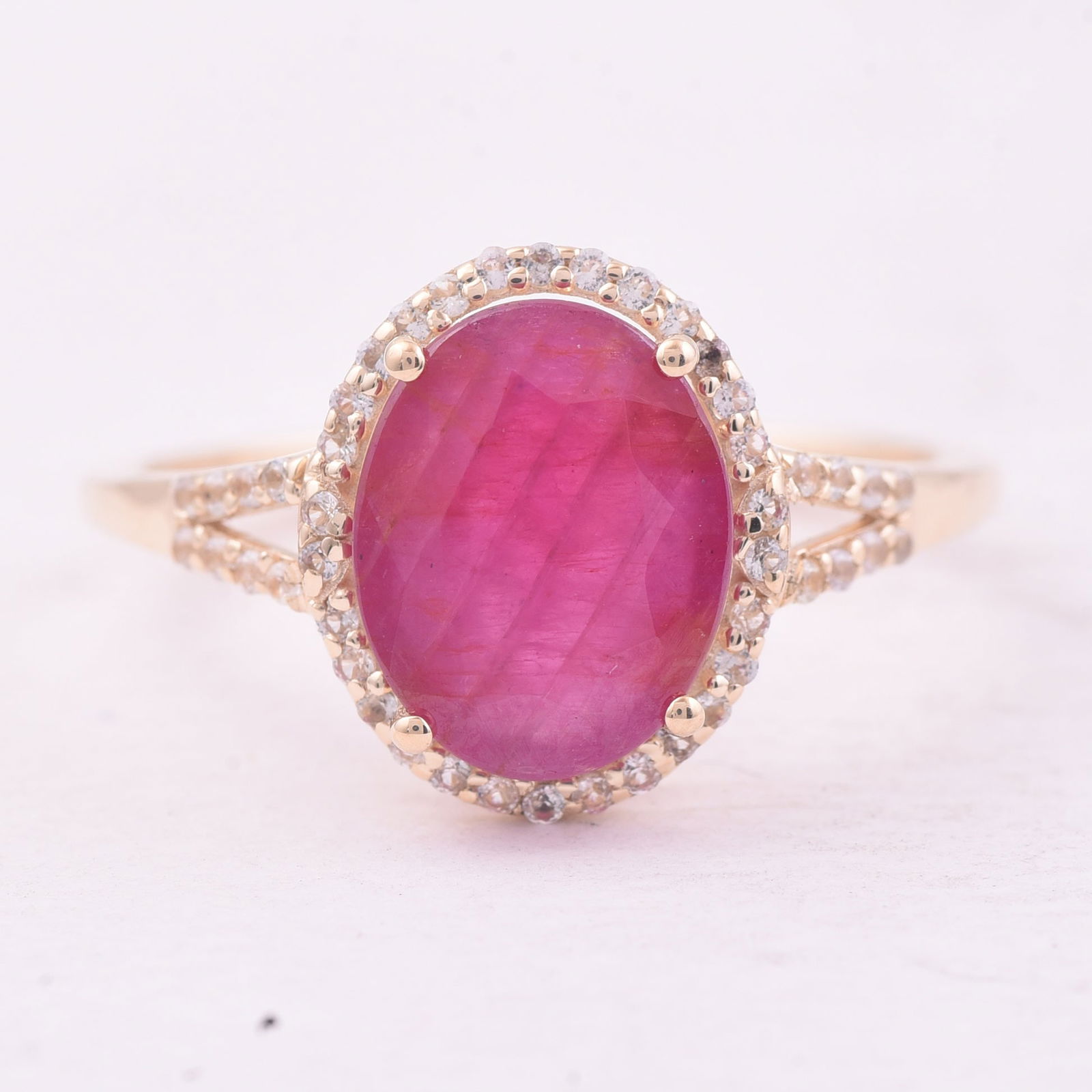 2.91 Ct Oval Ruby 9K Gold Ring: 2.91 Total Carat Ruby 9K Gold Ring Specifications - Total Weight 2.105 g - Center Gemstone Ruby - Gemstone Carat Weight 2.69 Carats - Gemstone Measurements 10X8 mm - Additional Gemstones White