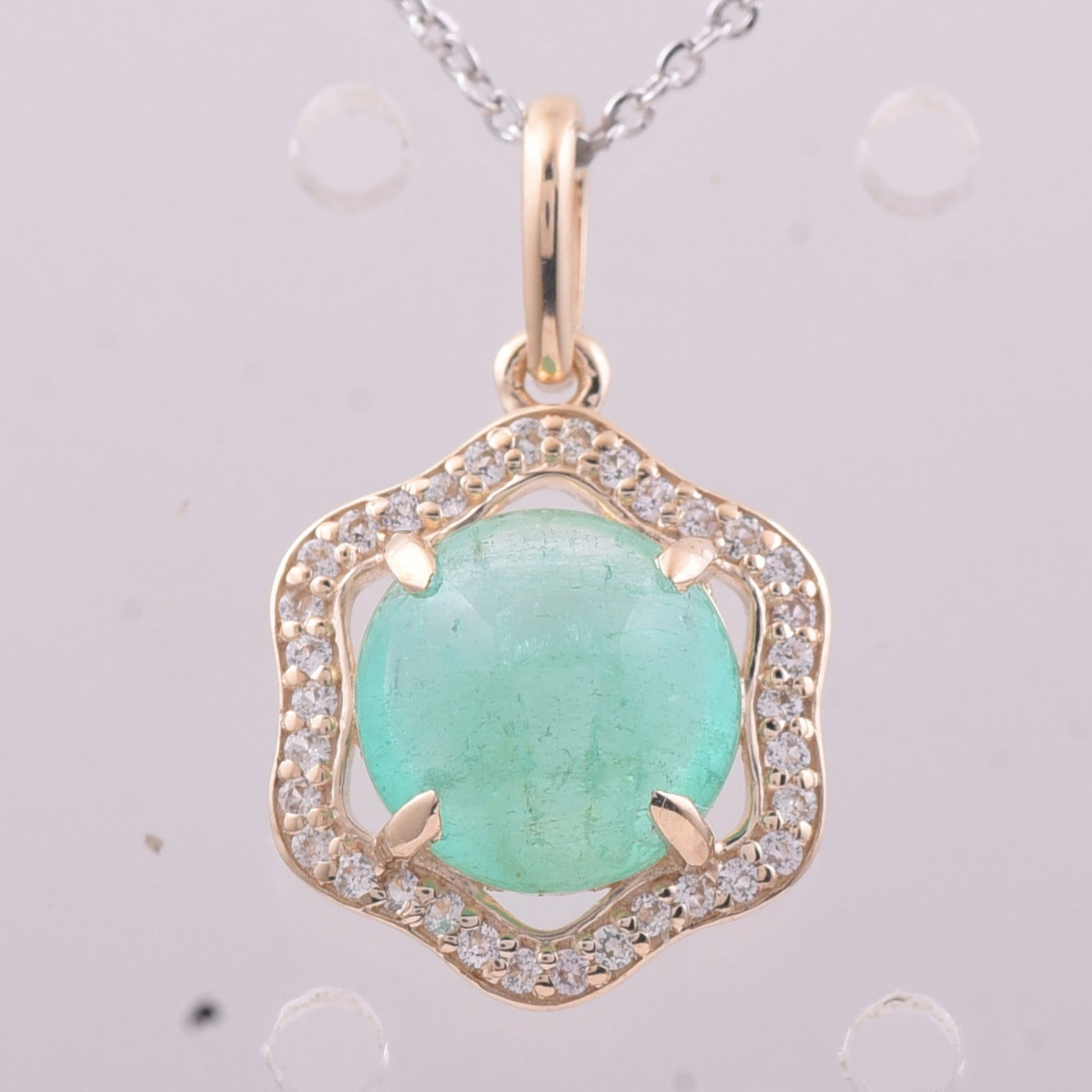 2.00 Ct Round Emerald 9K Gold Pendant: 2.00 Total Carat Emerald 9K Gold Pendant Specifications - Total Weight 1.179 g - Center Gemstone Emerald - Gemstone Carat Weight 1.86 Carats - Gemstone Measurements 8 mm - Additional Gemstones White