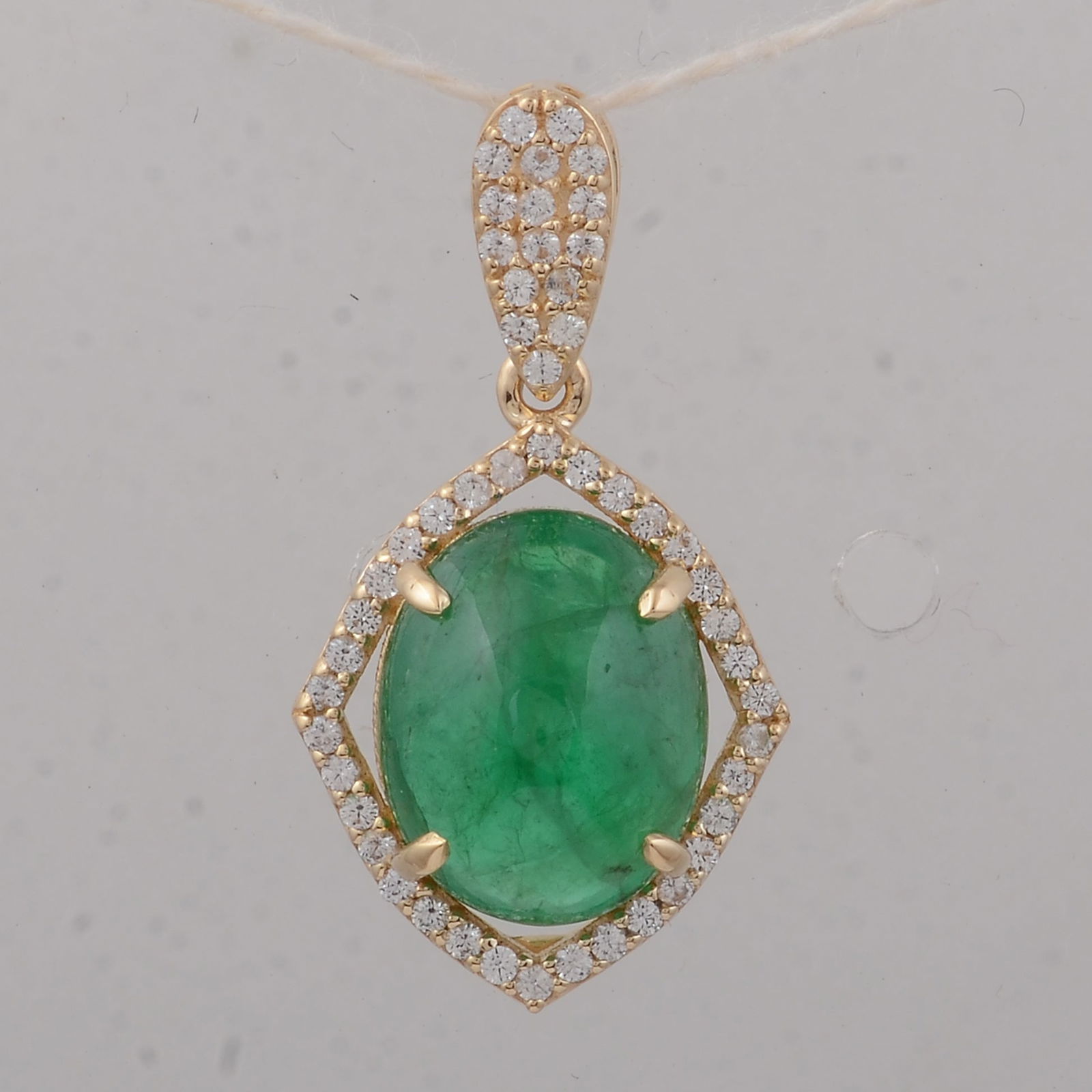 3.31 Ct Oval Emerald 9K Gold Pendant: 3.31 Total Carat Emerald 9K Gold Pendant Specifications - Total Weight 1.56 g - Center Gemstone Emerald - Gemstone Carat Weight 3.1 Carats - Gemstone Measurements 10X8X5.90 mm - Additional Gemstones W