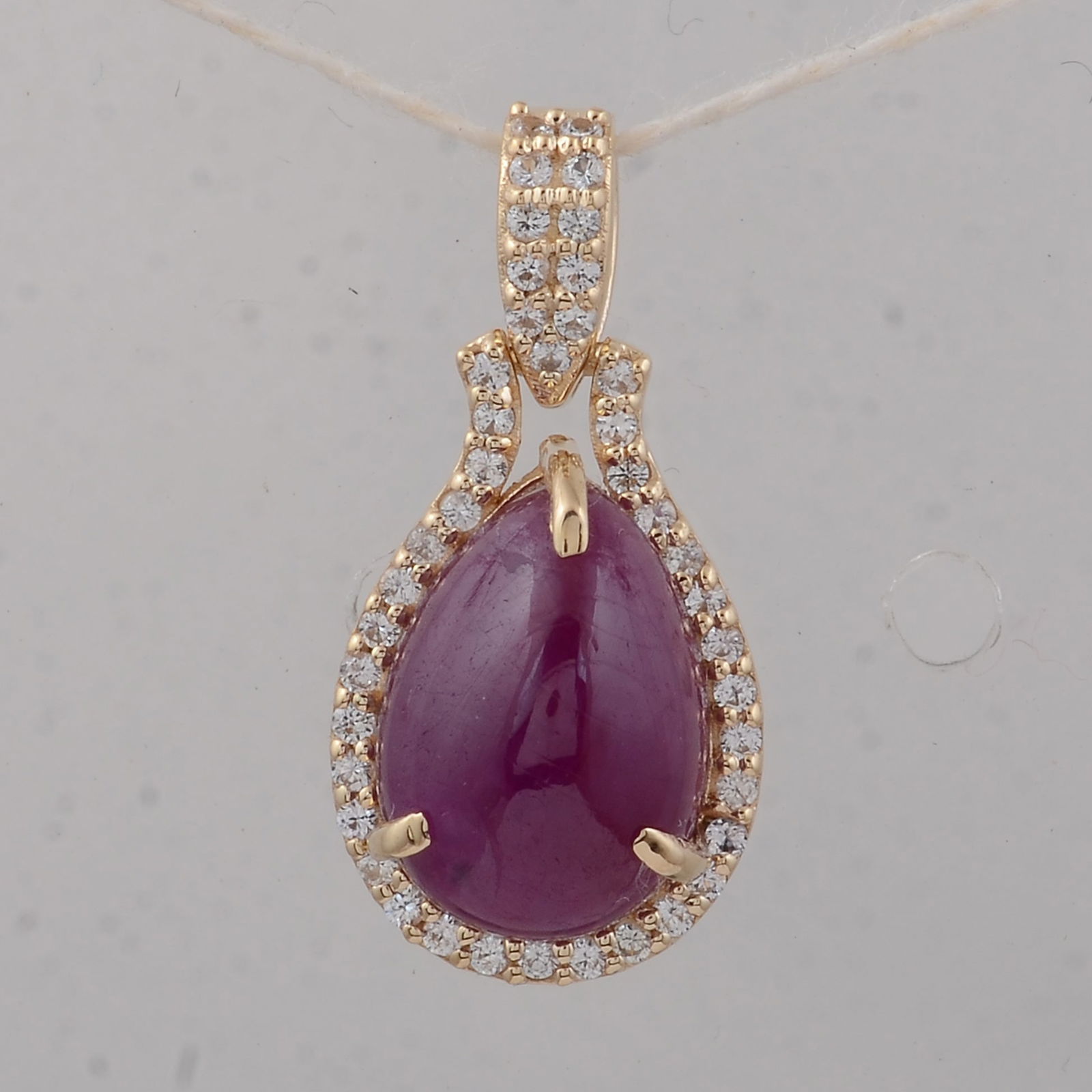 3.85 Ct Pear Ruby 9K Gold Pendant: 3.85 Total Carat Ruby 9K Gold Pendant Specifications - Total Weight 1.61 g - Center Gemstone Ruby - Gemstone Carat Weight 3.68 Carats - Gemstone Measurements 10X7 mm - Additional Gemstones White Sapph