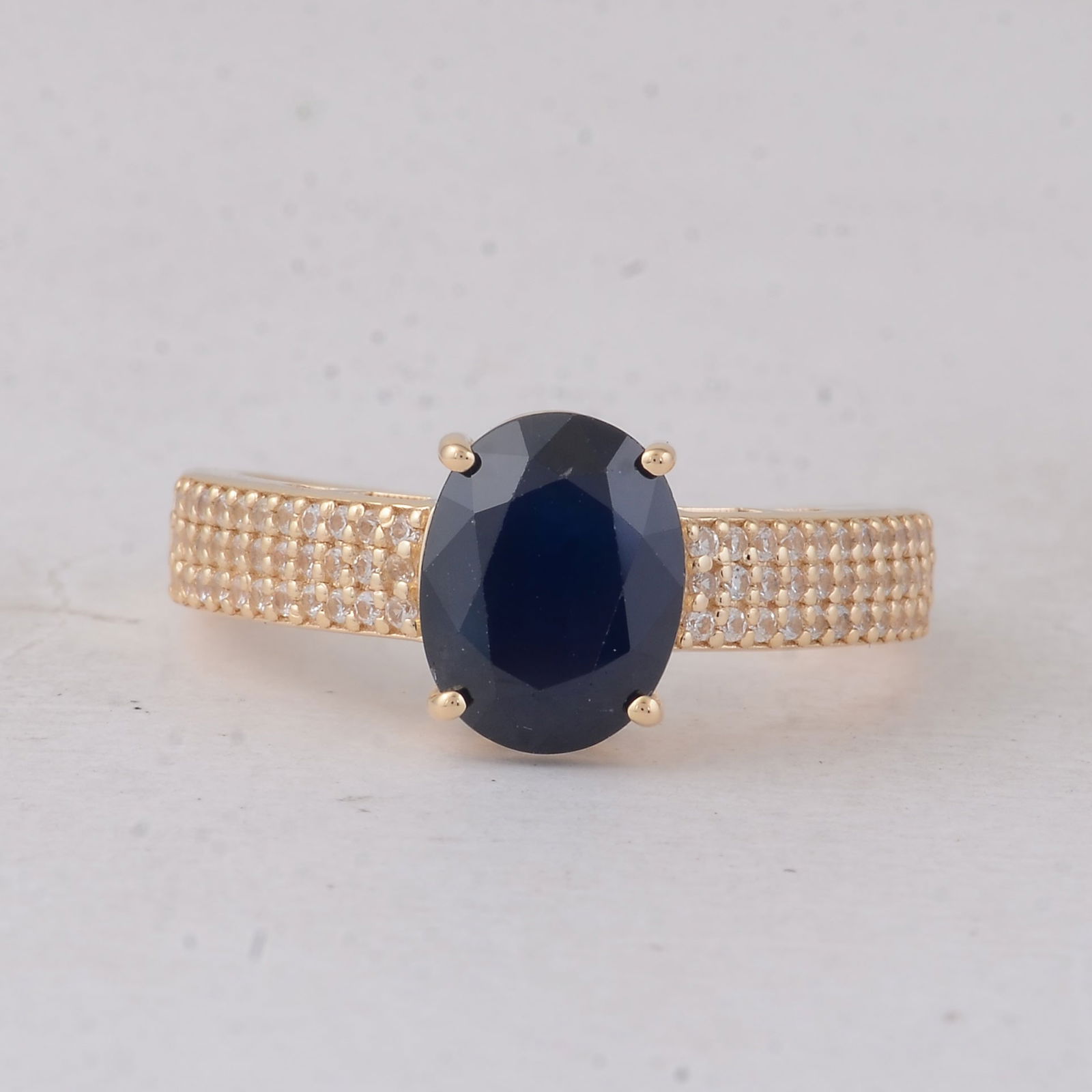 2.86 Ct Oval Sapphire 9K Gold Ring: 2.86 Total Carat Sapphire 9K Gold Ring Specifications - Total Weight 2.746 g - Center Gemstone Sapphire - Gemstone Carat Weight 2.57 Carats - Gemstone Measurements 9X7X4.60 mm - Additional Gemstones W