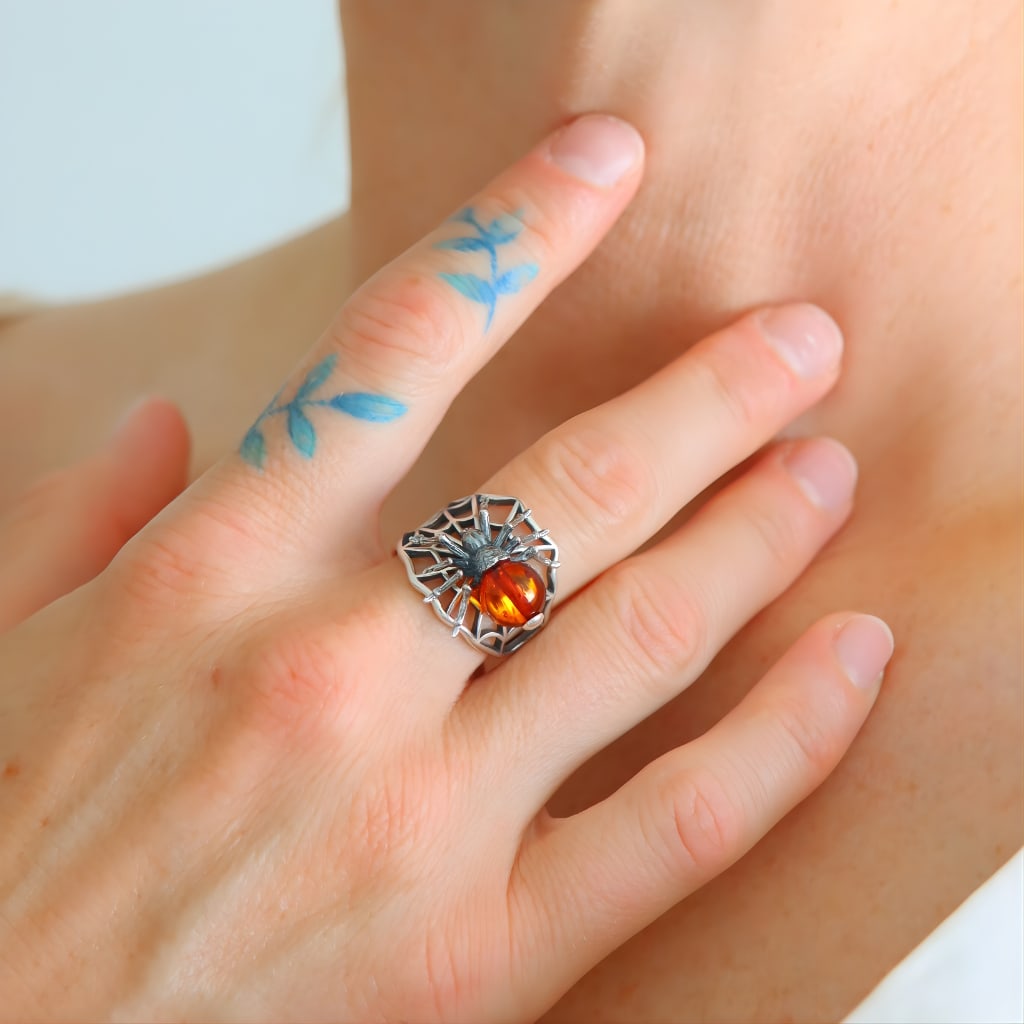Cherry Baltic Amber Spider - Sterling Silver Ring: Title:Cherry Baltic Amber Spider - Sterling Silver RingDescription:This Natural Baltic cherry amber spider ring is a bold and detailed sterling silver ring that highlights creativity and design.