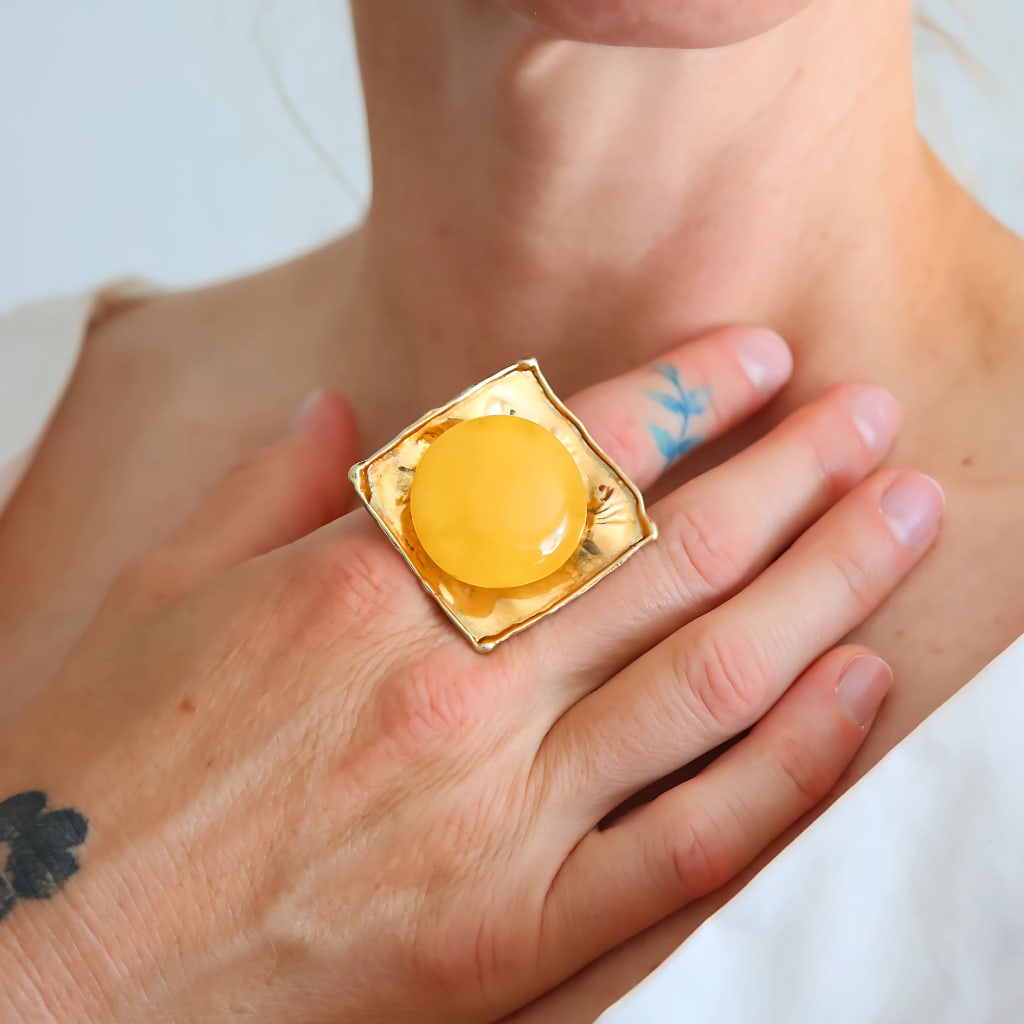 Handmade Butterscotch Amber Ring – Adjustable 14k Gold Plated Sterling Silver: Title:Handmade Butterscotch Amber Ring – Adjustable 14k Gold Plated Sterling SilverDescription:This bold butterscotch amber ring features a genuine Baltic egg yolk amber cabochon set in 14k
