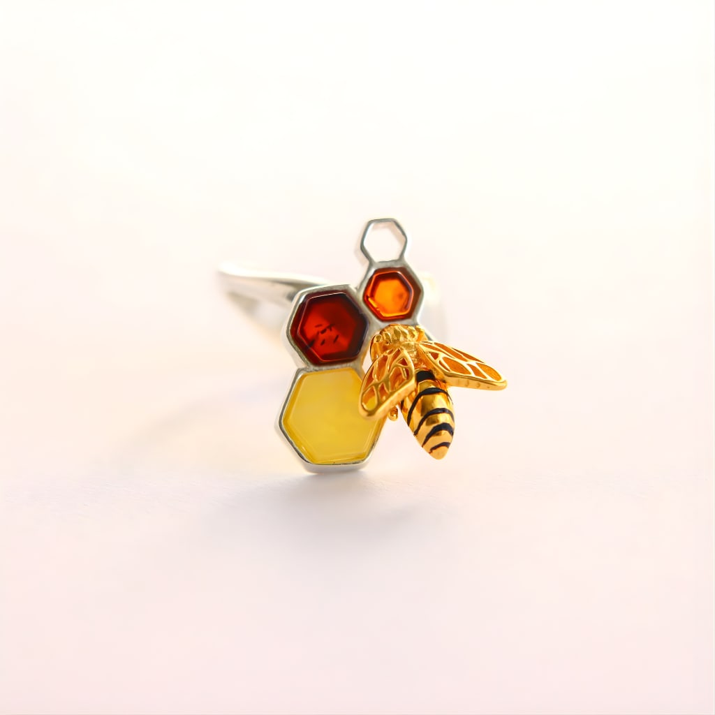 Gold Bee and Honeycomb Amber Ring- 14k Gold Plated Sterling Silver: Title:Gold Bee and Honeycomb Amber Ring- 14k Gold Plated Sterling SilverDescription:This amber ring features a honeycomb-inspired design set with genuine Baltic amber in warm butterscotch and deep