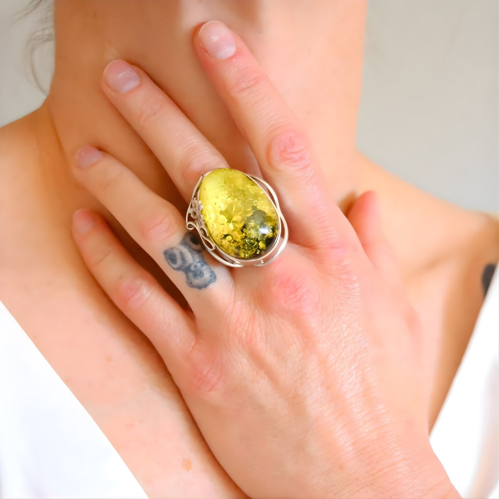 Baltic Green Amber Sterling Silver Ring- Handmade: Title:Baltic Green Amber Sterling Silver Ring- Handmade Description:This sterling silver ring features a large oval Baltic green amber stone set in a sculptural silver mount. The amber contains dense