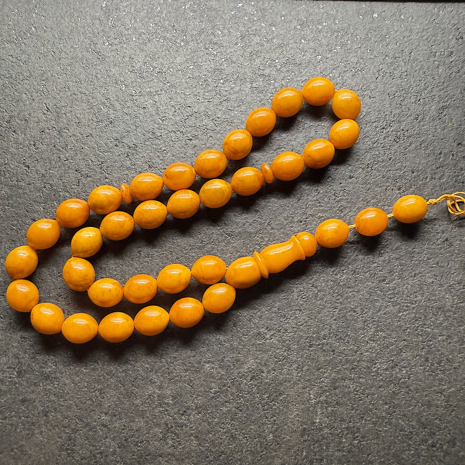 Alluring Amber Tesbih made from Olive shaped Amber beads: Title:Alluring Amber Tesbih made from Olive shaped Amber beadsMetal:NoneGemstone:AmberWeight:35.3 gSize:Bead size: 11.0 x 13.0 mm Bead size: 0.433 x 0.512 inches Made of:(Reconstituted Amber or Whole