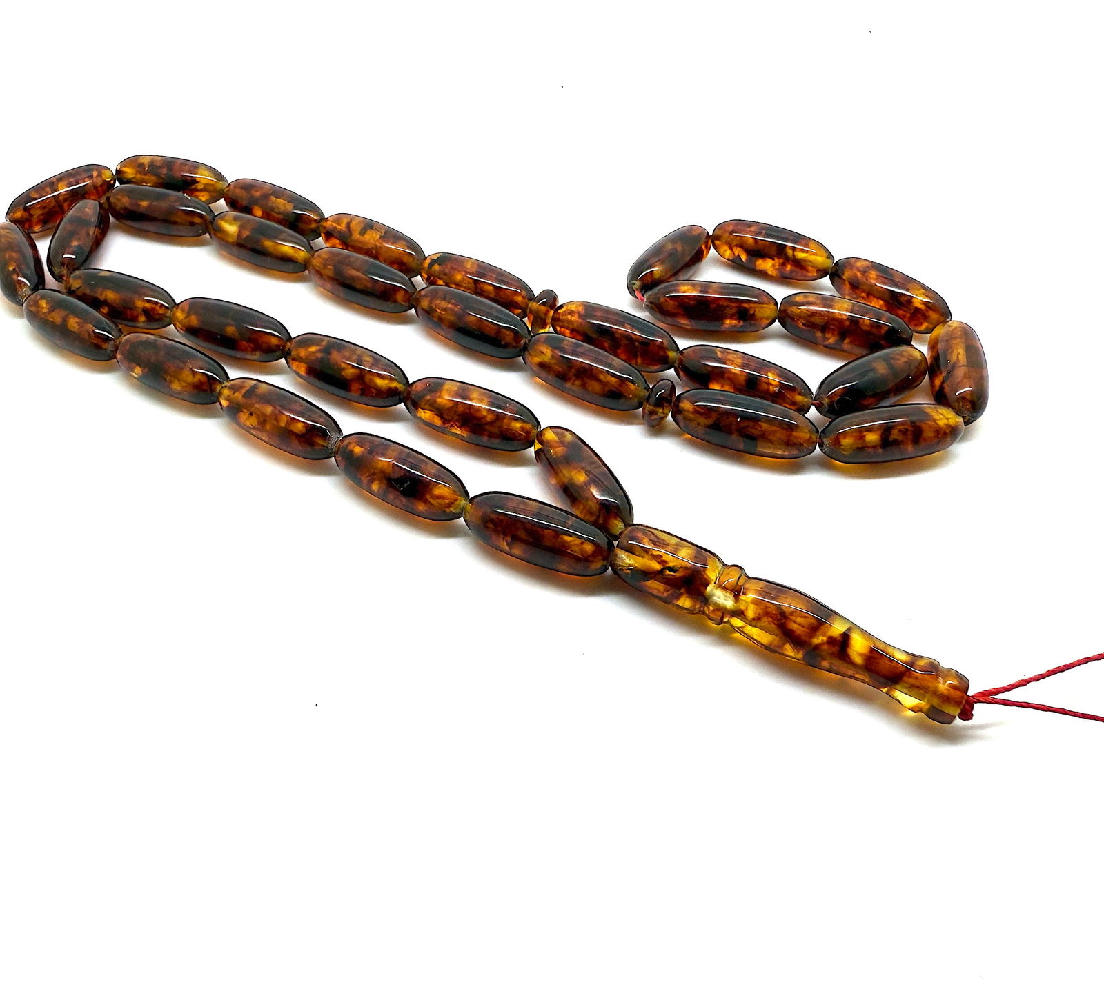 Staggering Vintage Amber Tesbih made from Capsule shaped Amber beads: Title:Staggering Vintage Amber Tesbih made from Capsule shaped Amber beads Metal:None Gemstone:Amber Weight:31.2 g Size:Bead size: 20.0 x 8.0 mm Bead size: 0.787 x 0.315 inches Made of:(Reconstituted