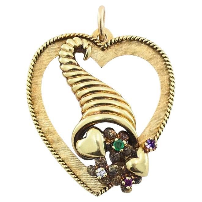 Vintage 14k Gold Heart Pendant Gemstone Cornucopia Design: Title: Vintage 14k Gold Heart Pendant Gemstone Cornucopia Design Description: About the Item This 14k gold heart pendant showcases a central cornucopia design within an elegant open‑work frame.