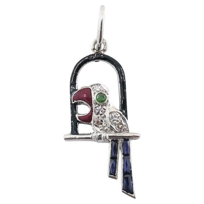 Antique Platinum Parrot Charm Gemstone Diamond Accents: Title: Antique Platinum Parrot Charm Gemstone Diamond Accents Description: About the Item This charming 1910s platinum parrot pendant features a stylized bird perched in an arched cage, accented with