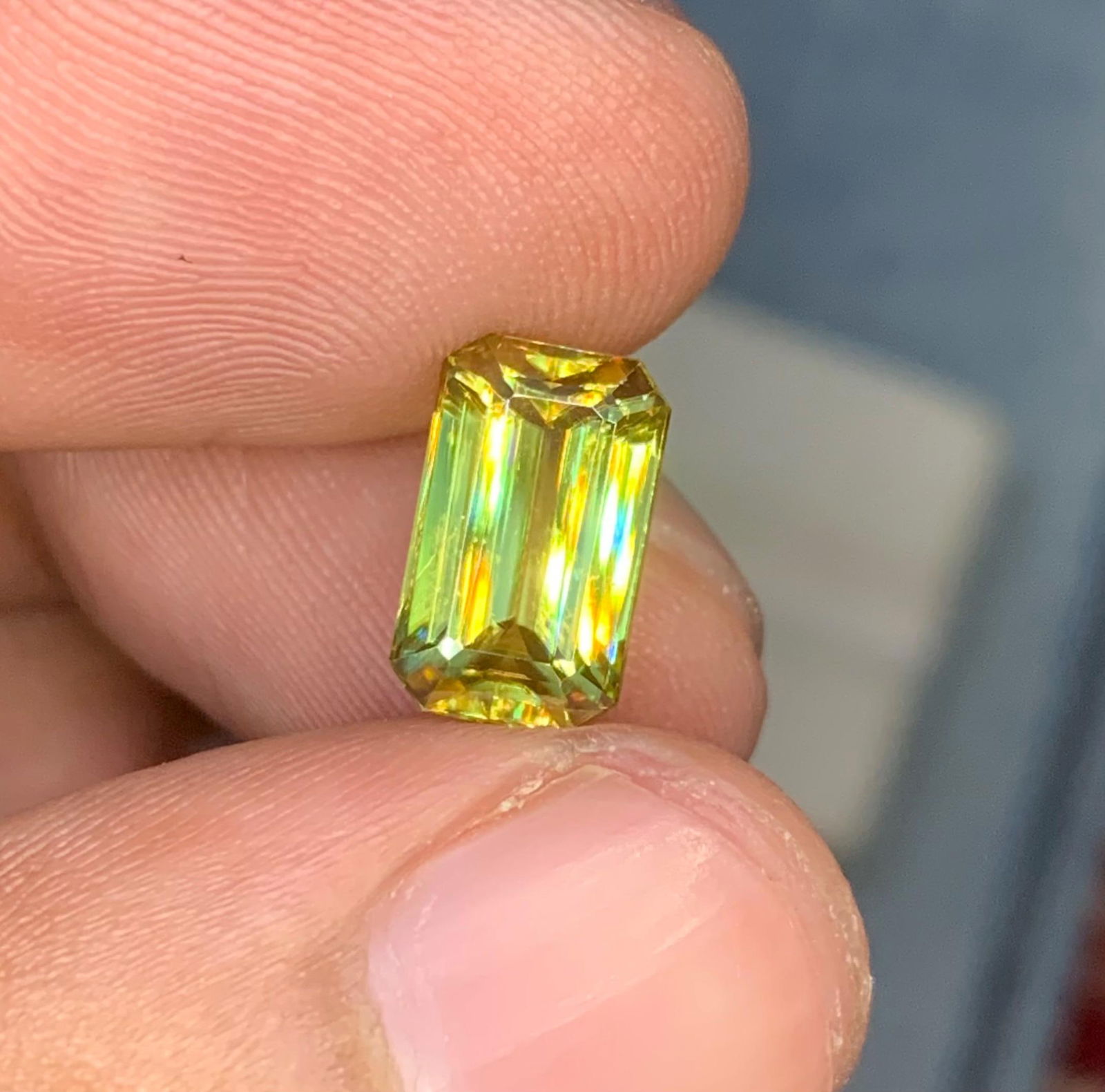 Emerald Cut Yellow Sphene Gemstone: 3.40 Carat Titanite: Materials: Gemstone: Sphene Carat weight: 3.40 This stunning full fire sphene titanite loose gemstone features a classic Emerald cut that enhances its brilliance and beauty. With its vibrant play of c