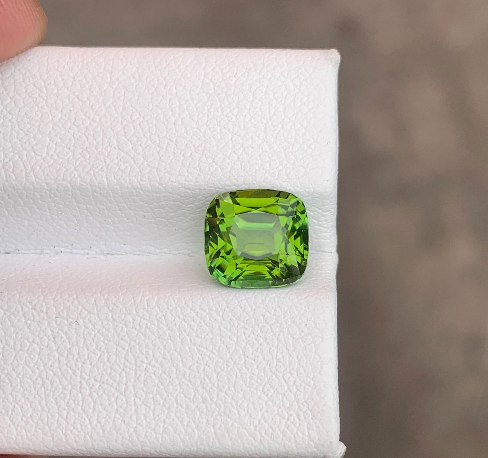 Apple Green Tourmaline Gemstone: 3.415 Ct Cushion Cut, Afghanistan: Materials: Gemstone: Tourmaline Carat weight: 3.415 About this item Weight : 3.415 CT Dimensions : 8.52 x 8.1 x 6.3 MM Shape : Cushion Clarity : Eye Clean Color : Apple Green Treatment : None Origin
