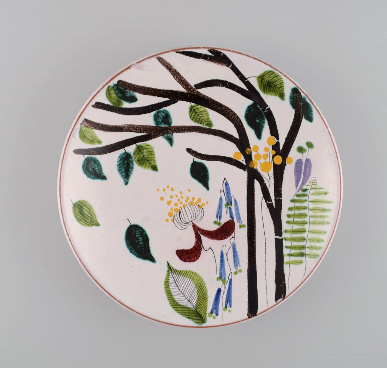 Stig Lindberg for Gustavsberg Studiohand. Round dish in glazed faience with hand-painted flowers.: Title: Stig Lindberg for Gustavsberg Studiohand. Round dish in glazed faience with hand-painted flowers. 1940s. Description: Stig Lindberg for Gustavsberg Studiohand. Round dish in glazed faience with