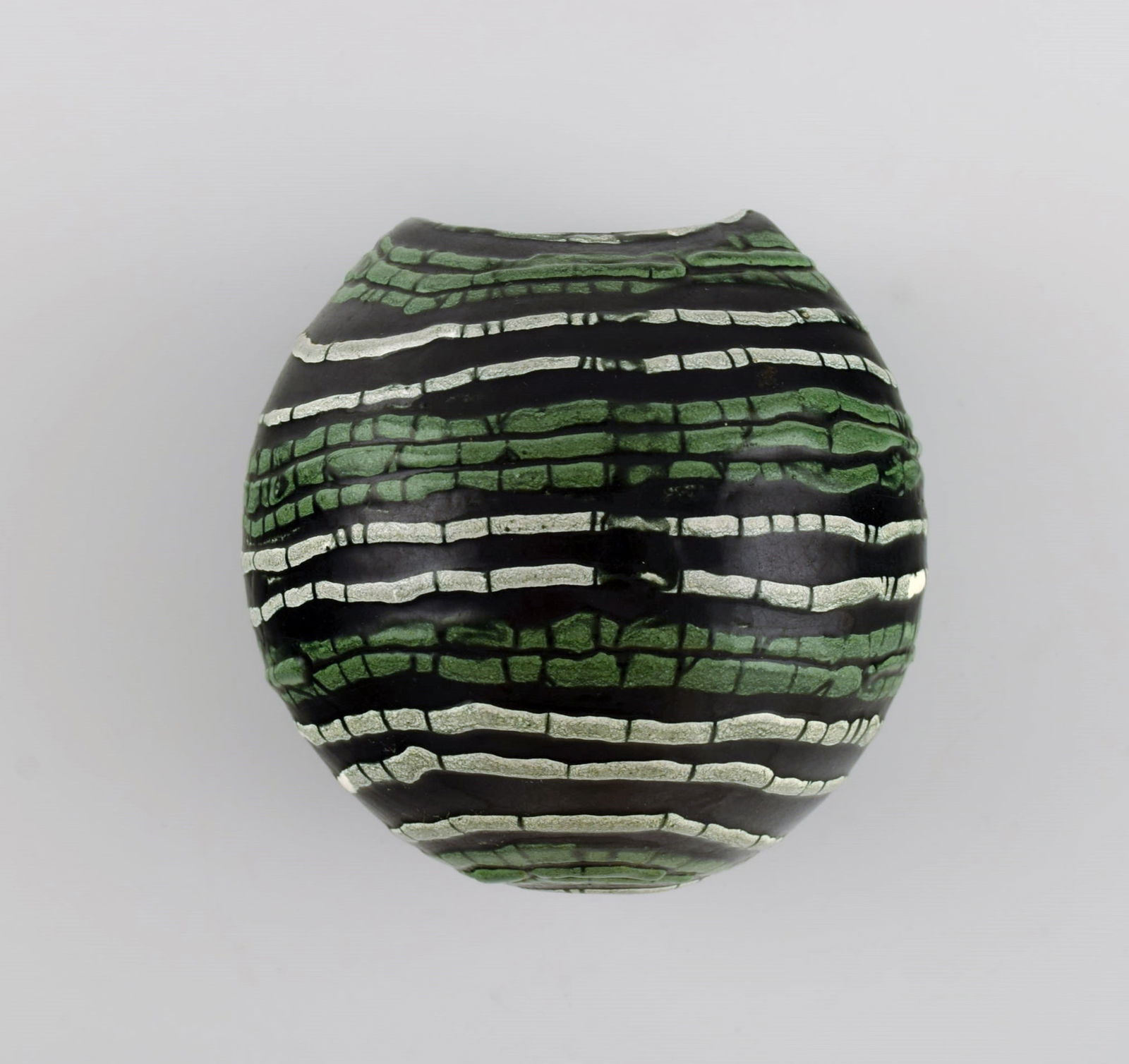 European studio ceramicist. Unique flowerpot for wall hanging in glazed ceramics. Green and white: Title: European studio ceramicist. Unique flowerpot for wall hanging in glazed ceramics. Green and white stripes on black background. 1960s / 70s. Description: European studio ceramicist. Unique