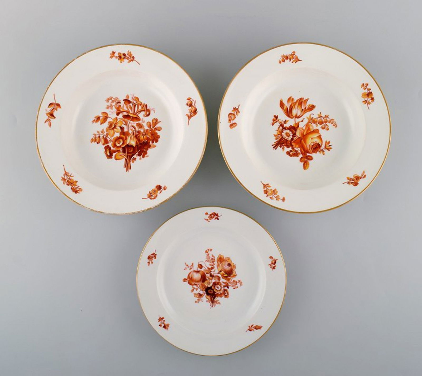 Three antique Meissen porcelain plates with orange hand-painted flowers. Two deep plates and one: Title: Three antique Meissen porcelain plates with orange hand-painted flowers. Two deep plates and one lunch plate. 19th century. Description: Three antique Meissen porcelain plates with orange