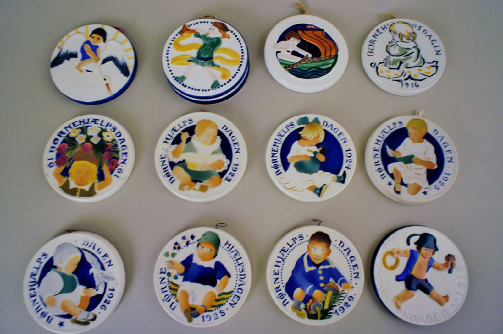 Aluminia child day year-plates.: Title: Aluminia child day year-plates. Description: Aluminia child day year-plates in faience. In good condition, Measures 8.5 cm. Years: 1912,16 and 24-28 (minus 1926, 1927) Reserve: $25.00 