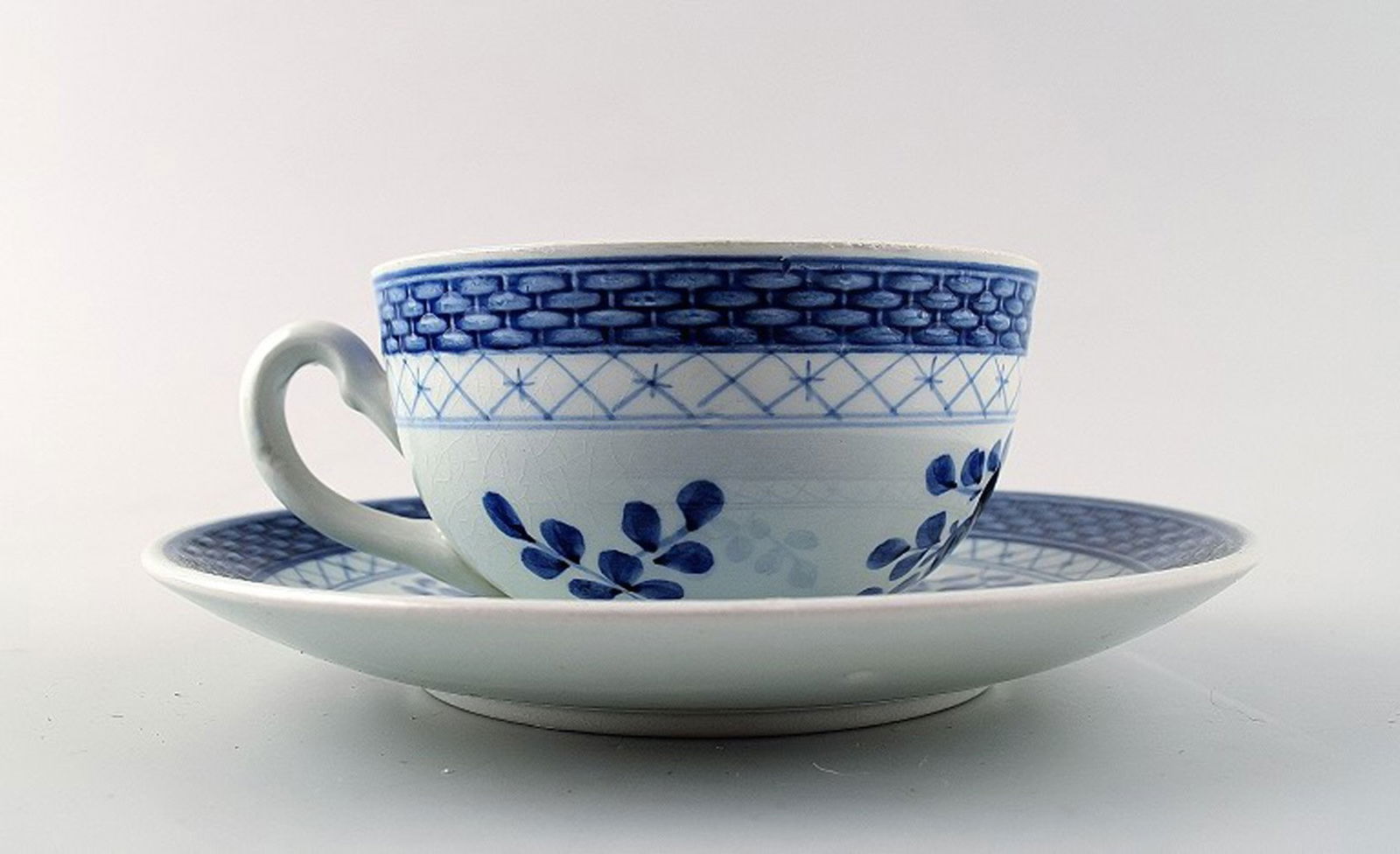 Set of Aluminia Tranquebar. Small chocolate / teacup with saucer. 12 sets in stock.: Title: Set of Aluminia Tranquebar. Small chocolate / teacup with saucer. 12 sets in stock. Description: 12 set of Aluminia Tranquebar. Small chocolate / teacup with saucer. Number. 11/1190. Height