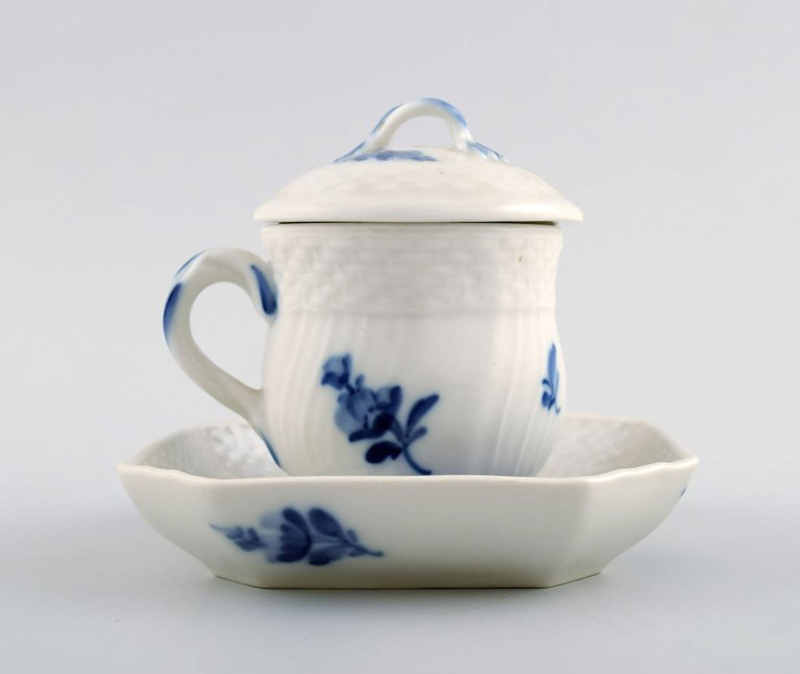 Royal Copenhagen Blue Flower braided, cream cup with square saucer.: Title: Royal Copenhagen Blue Flower braided, cream cup with square saucer. Description: Royal Copenhagen Blue Flower braided, cream cup with square saucer. Decoration Number 10/1542. Height 8.5 cm. Pe