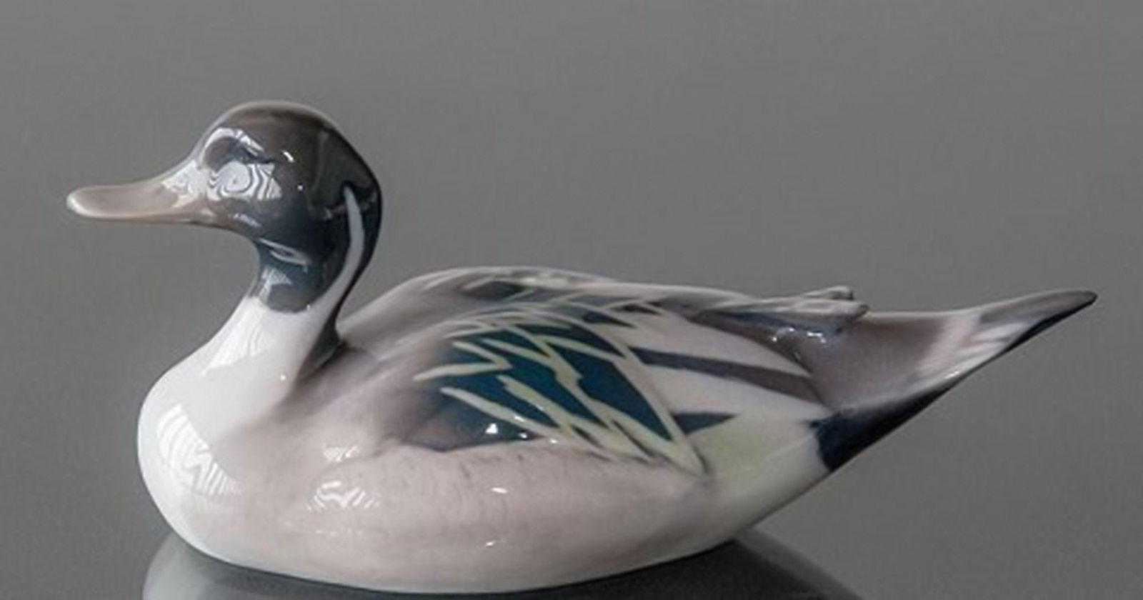 Royal Copenhagen duck, figurine number 1933.: Title: Royal Copenhagen duck, figurine number 1933. Description: Royal Copenhagen duck, figurine number 1933. Technique: Underglaze. Designer: Peter Herold. No longer in production. 16 cm. long.