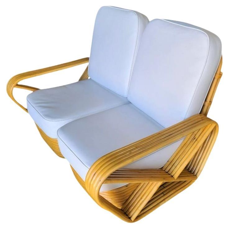 Restored 5-Strand Square Square Pretzel Rattan Settee w/ Stacked Base: Title: Restored 5-Strand Square Square Pretzel Rattan Settee w/ Stacked Base Description: Designed in the manner of Paul Frankl this Five-strand rattan Sectional Setee features square pretzel arms and