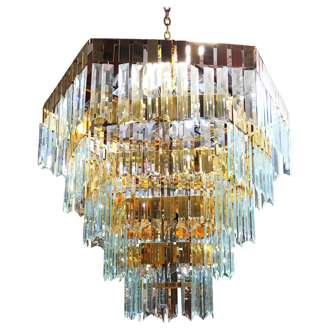 1970's Late Modernist Hanging Crystal and Brass Chandelier, 2 Available: Title: 1970's Late Modernist Hanging Crystal and Brass Chandelier, 2 Available Description: Circa 1970s late Modernist hanging crystal brass chandelier featuring a 5-level brass-framed chandelier