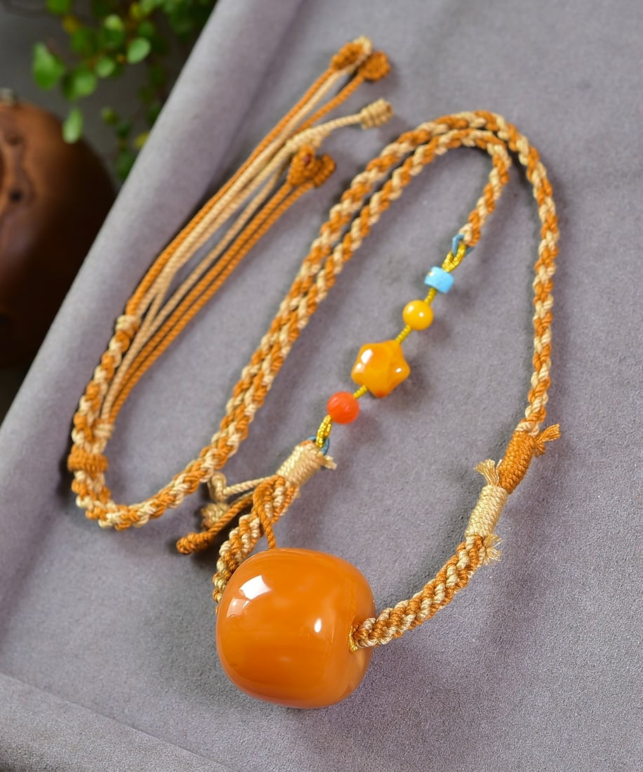 Yellow Beeswax Lucky Pendant: Title: Yellow Beeswax Lucky Pendant Origin: Chinese Date/Period: After2025 Materials: Beeswax Dimensions: 33x29(mm) 1.30x1.14(inches) Weight 0.07 lbs/30.4g Reserve: $118.00 Shipping:Domestic: