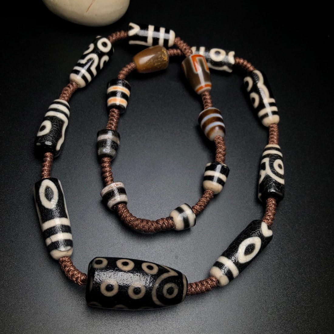 Tibetan DZI Agate Necklace: Title: Tibetan DZI Agate Necklace Origin: Date/Period: Materials: DZI Agate Dimensions: 11x10(mm) 0.43x0.39(inches) 41x20(mm) 1.61x0.79(inches) Reserve: $99.00 Shipping: Domestic: Shipping rate
