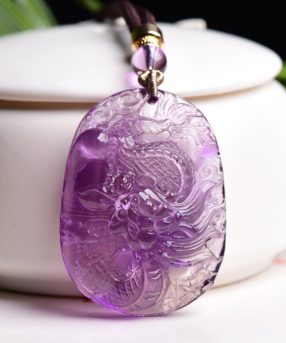 Natural Amethyst Hand-Carved Dragon Pendant: Title: Natural Amethyst Hand-Carved Dragon Pendant Origin: Chinese Date/Period: After2020 Materials: Amethyst Dimensions: 47x34.3x16(mm) 1.85x1.35x0.63(inches) Weight 0.08 lbs/36.1g Reserve: $599.00 S