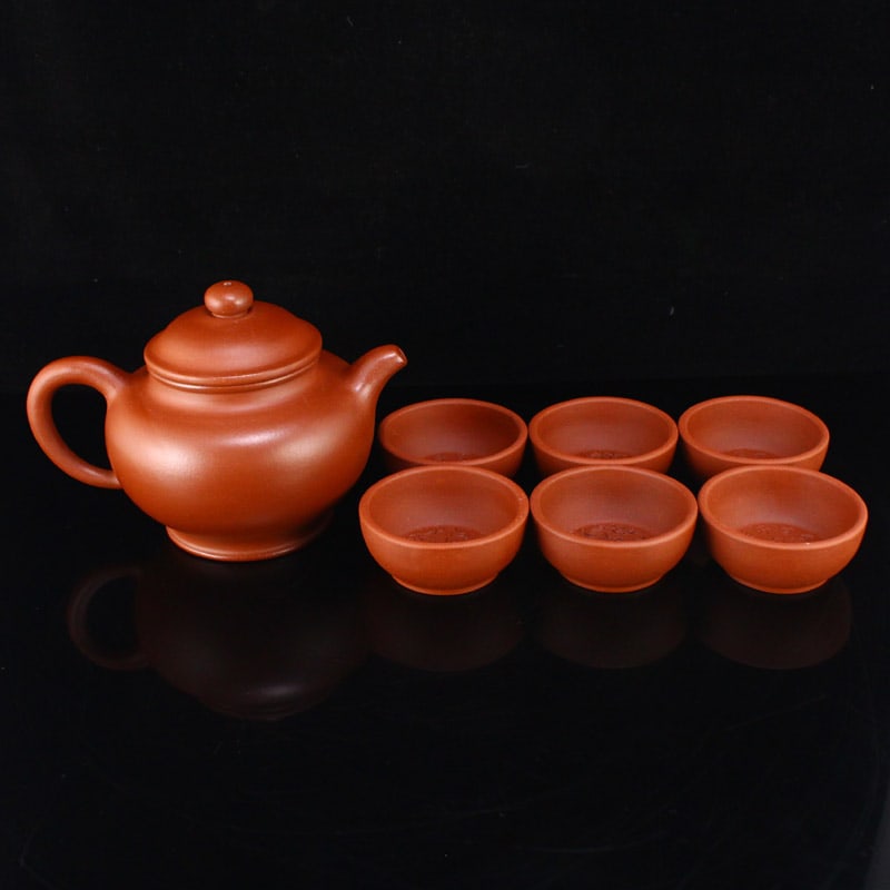A Set Yixing Zisha Clay Teapot & Cup: Title: A Set Yixing Zisha Clay Teapot & Cup Origin: Chinese Date/Period: Materials: Zisha Dimensions: 100x150x110(mm) 3.94x5.91x4.33(inches) 26x60x60(mm) 1.02x2.36x2.36(inches) Weight 1.21lbs/549g Res