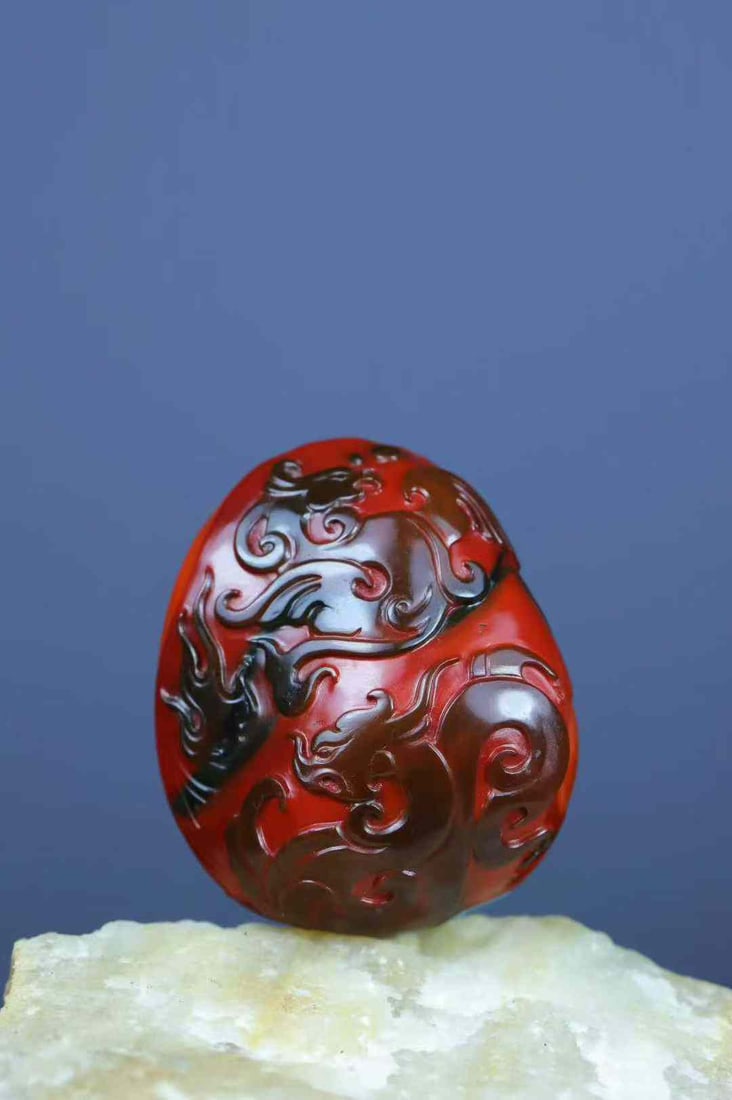 Nanhong Agate Hand-Carved Dragon Phoenix Pendant with Certificate: Title: Nanhong Agate Hand-Carved Dragon Phoenix Pendant with Certificate Origin: Chinese Date/Period: After2025 Materials: Nanhong Agate Dimensions: 32x27x16(mm) 1.26x1.06x0.63(inches) Weight 0.04 lbs