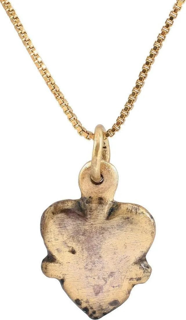 RARE VIKING HEART NECKLACE, 9TH-10TH CENT AD: Gilt bronze. Under 3/4" height of domed form defining the fully evolved cusped top heart with nubs at the waist. Made by the open face mold technique and of full thick section. Professionally refurbis