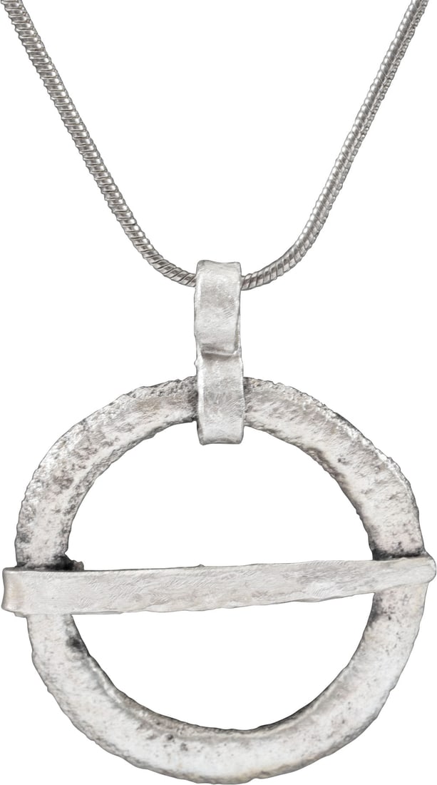 RARE VIKING PROTECTIVE BROOCH 10th-11th CENTURY AD: Bronze, large, just over 1 1/8" (1.14”) diameter of domed form. Broad band decorated originally, now obscured by degradation from burial. The edge slotted for the captive cross pin. Worn in mult