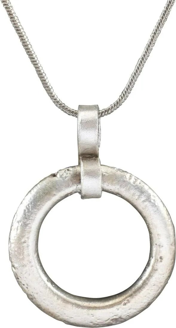 VIKING PROTECTIVE BROOCH PENDANT 10th-11th CENTURY: Good example, is circular bronze, just under 1" diameter of the thick section with rounded faces and ridged outer edge. The surface with remnants of a roped pattern. Would have been secured with a sep