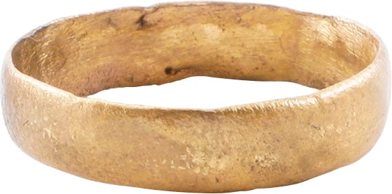 VIKING WEDDING RING, SIZE 10 3/4: Late 9th-early 11th century AD. Gilt bronze, size 10 ¾. 5.0mm width band with low rounded face. Made with a core filling the inside which distributed the flowing metal and allowed for slower cool