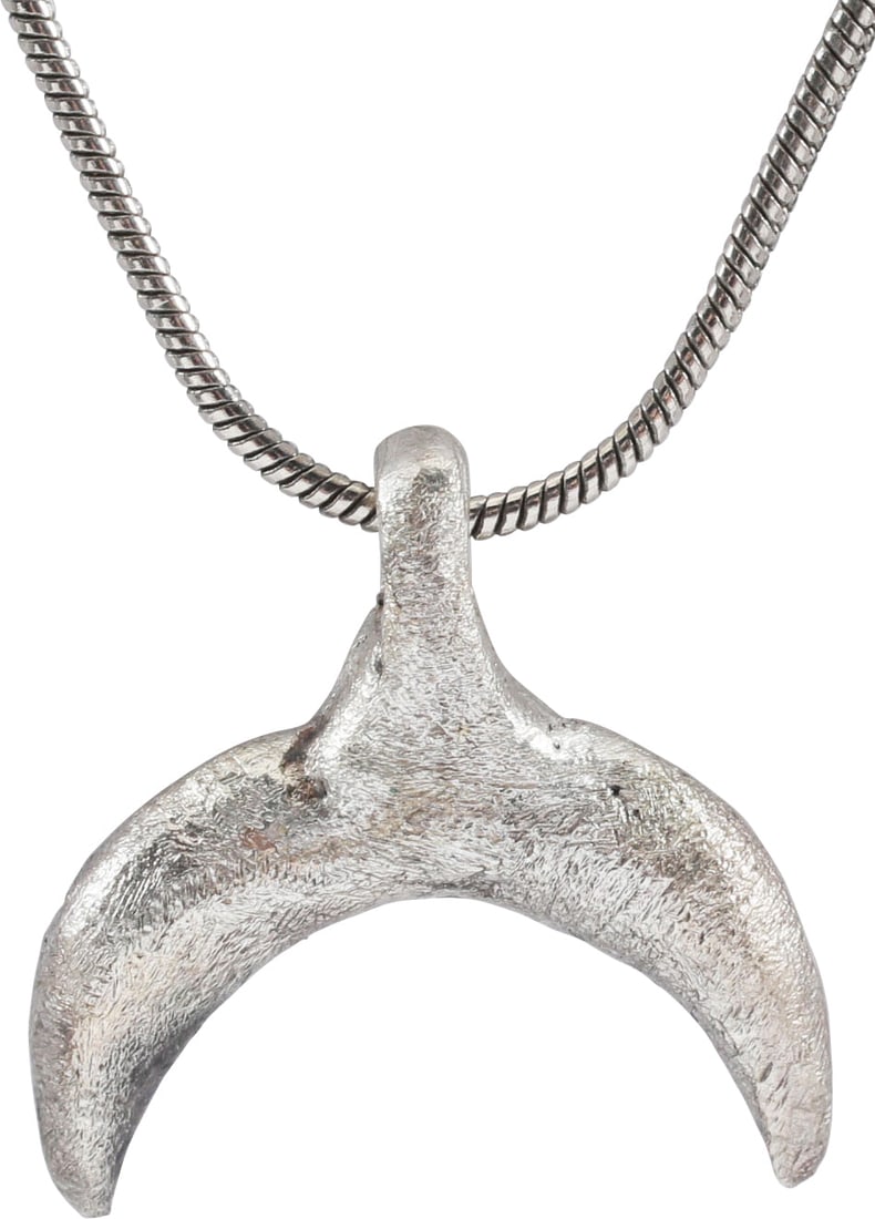 VIKING LUNAR PENDANT, 9th-10th C. AD: Gilt bronze, over 3/4" width (0.77"). Crescent form with the ends tapering from the swelled middle. As expert navigators, the constellations signified mystery and power to Vikings. The Moon was