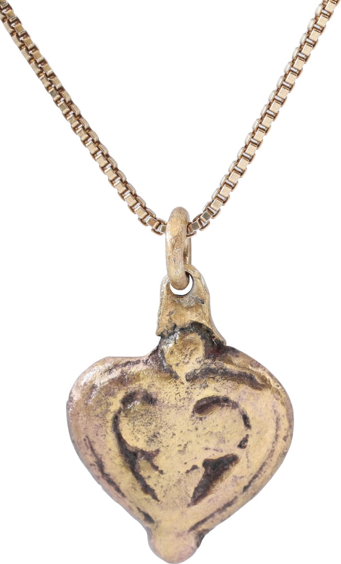 VIKING HEART PENDANT NECKLACE C.850-1050 AD.: Slightly over ½” (0.54”) height of fully evolved cusped top heart form with broad raised edge. The field with well-modeled raided addorsed trefoil over a v, emphasizing the bottom of