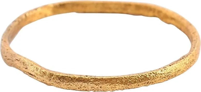 VIKING WEDDING RING, 850-1050 AD JEWELRY SIZE 9 3/4: Gilt bronze, size 9 3/4. Narrow 1.6mm width band with rounded face. Surface textured from burial and professionally refurbished with the 24karat gold surface restored. Vikings exchanged wedding rings